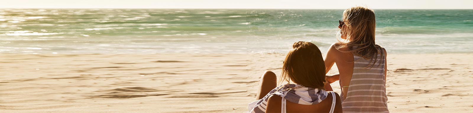 Women sitting on the sand at the beach