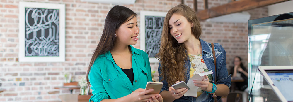 Two girls comparing their receipts