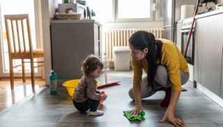 woman and young girl mopping kitchen floor