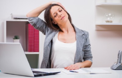Woman stretching her neck in the office