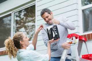 Couple painting house