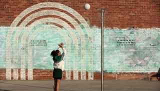 netball girl throwing ball in the hoop