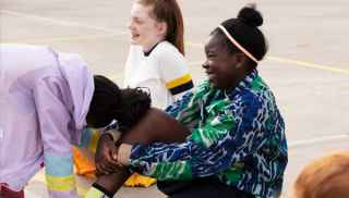 Netball girls laughing on court